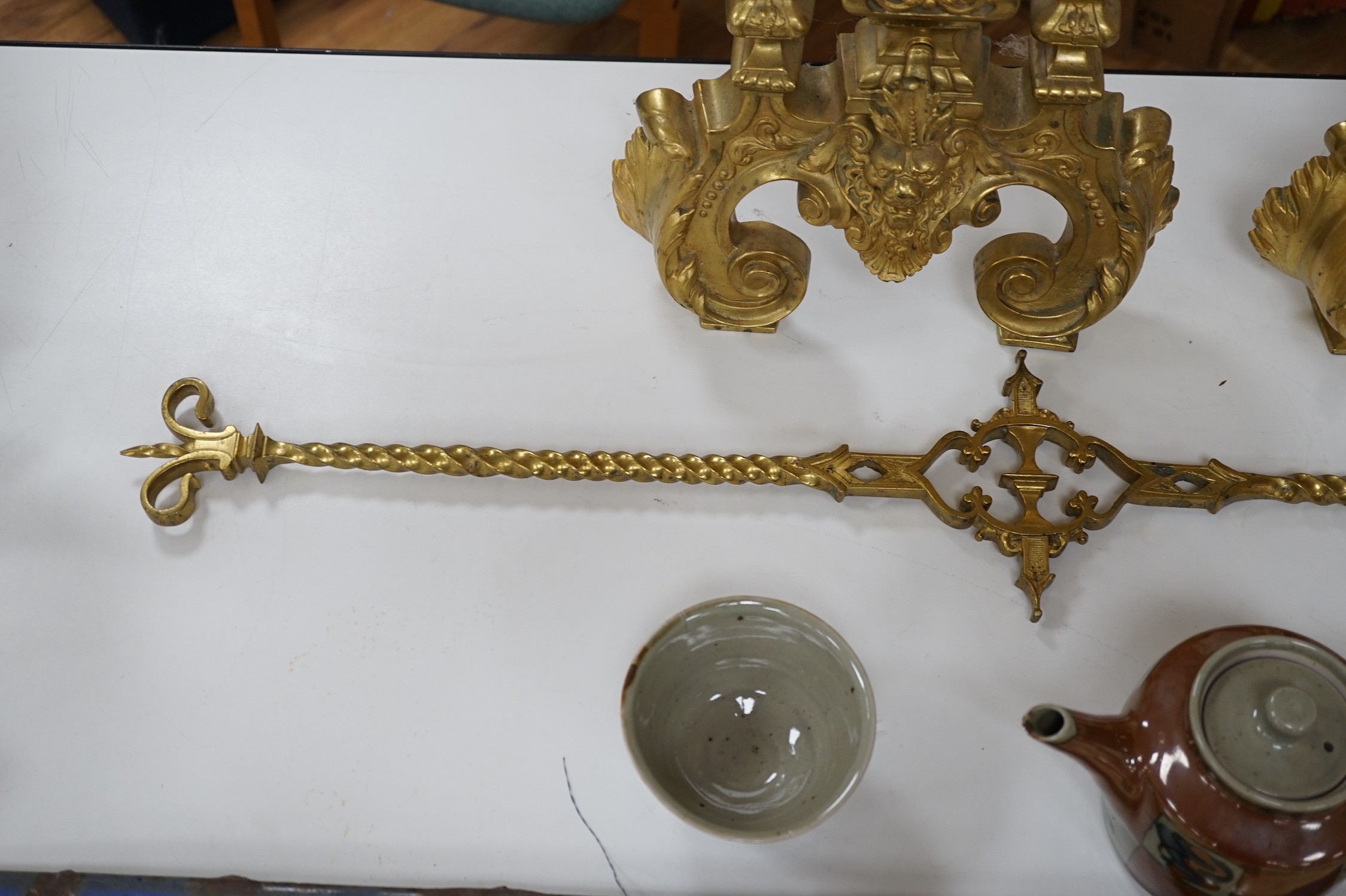A pair of cast brass fire dogs with adjustable bar, 52cms high